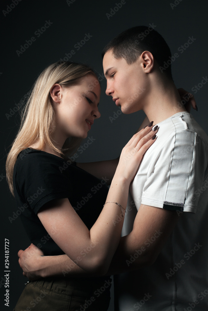 Young man and girl posing in studio. Young man and girl posing in studio.