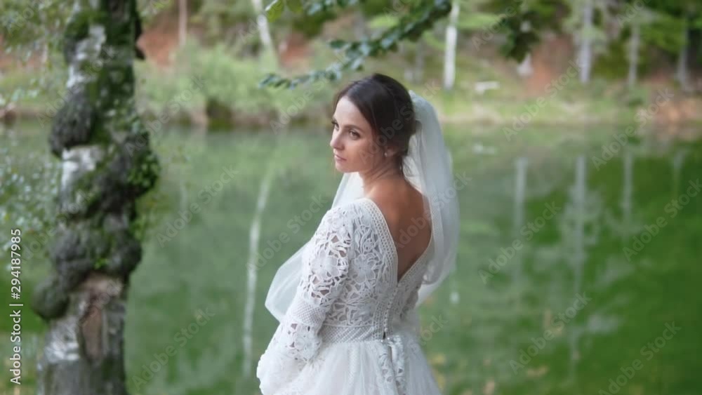 Wedding polish bride waiting/posing next to a lake, medium shot Wedding polish bride waiting/posing next to a lake, medium shot