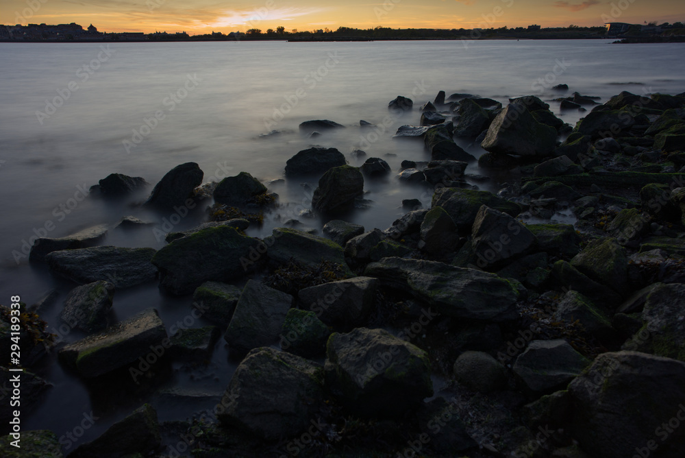 Moody landscape of Hudson River during sunset at Liberty State Park in New Jersey.