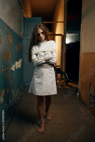 Canvas Print Female patient in straitjacket, mental hospital
