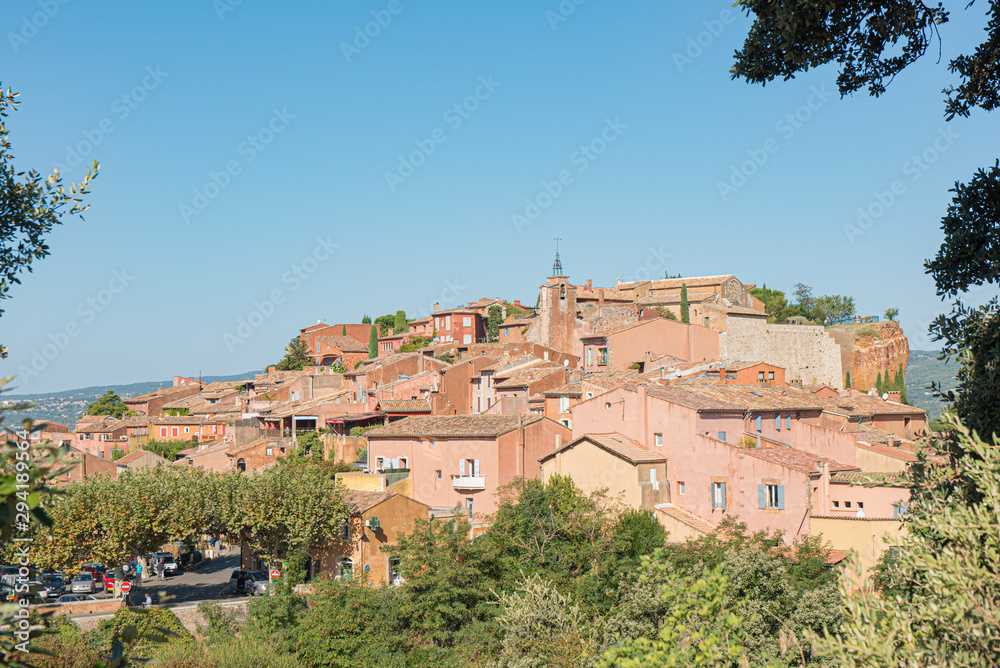 View of hilltop medieval ochre village of Roussillon, one of the most beautiful villages of France in a sunny summer day.