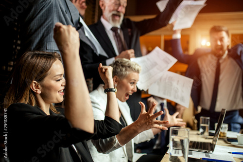 Bild auf Leinwand Group of professionals enthusiastically celebrating good deal consummation, rais