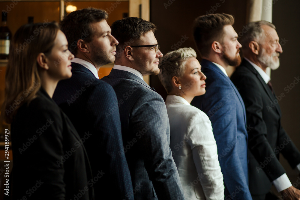 Portrait of self confident reserved people in business suites standing straight and looking away with tolerant expression. close up Portrait of self confident reserved people in business suites standing straight and looking away with tolerant expression. close up