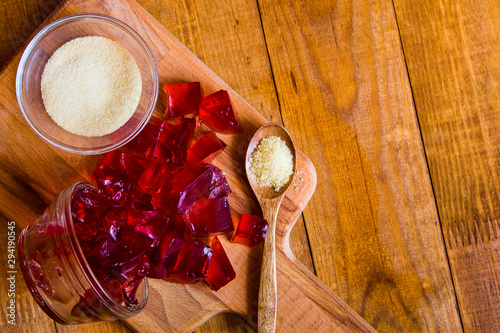 Gelatin powder and jelly on background