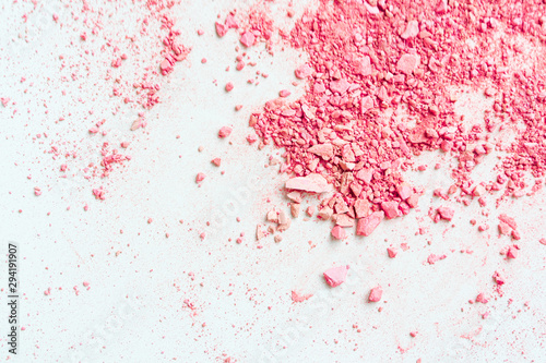 Smear of crushed pink blush on as sample of cosmetics product, copy space, top view.