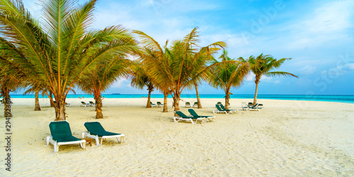 Lounge chairs on a beautiful tropical beach at Maldives © lotosfoto