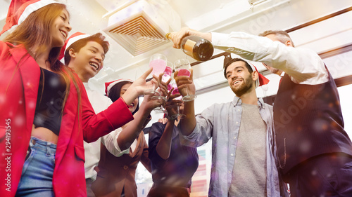 Canvas Print Group of office workers are celebrating Christmas party and happy new year by drinking champagne wine happily during the annual long break of the company And glad that the salary increases