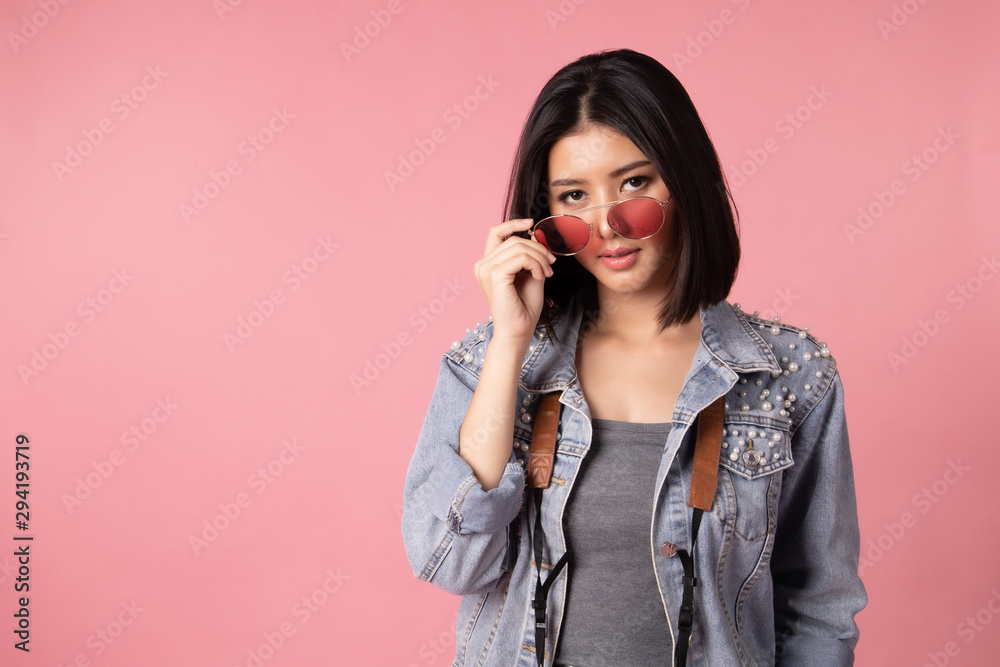 Tourist woman in summer casual clothes.Asian Smiling woman .Passenger traveling abroad to travel on pink background.She going to summer vacation.