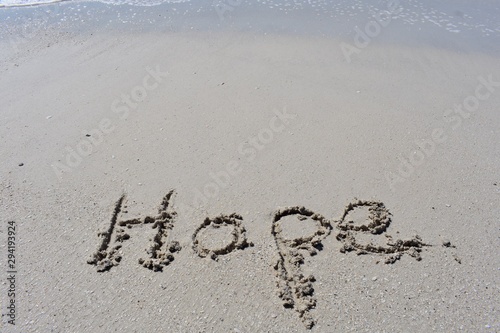 Background with hope written in the sand