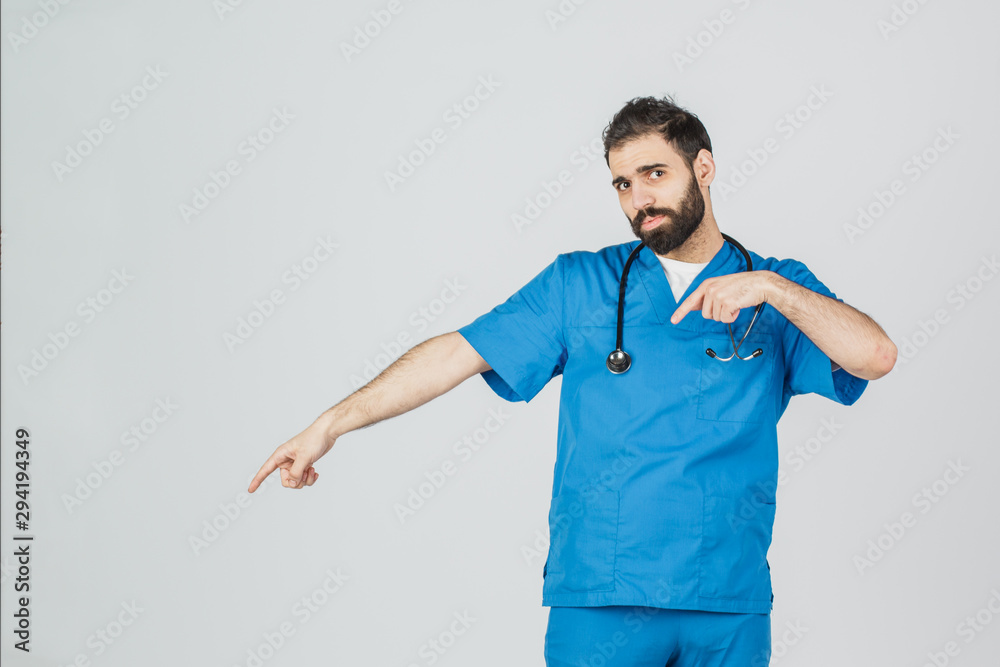 Portrait of doctor in blue uniform with his thumbs up. Isolated over white background people, medicine and healthcare Portrait of doctor in blue uniform with his thumbs up. Isolated over white background people, medicine and healthcare