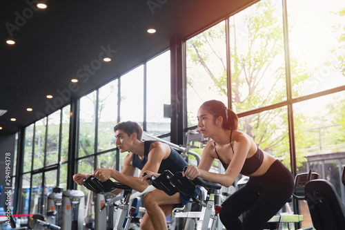 Healthy woman and man with sportswear running training on exercise at gym sport, bodybuilding, lifestyle and people concept