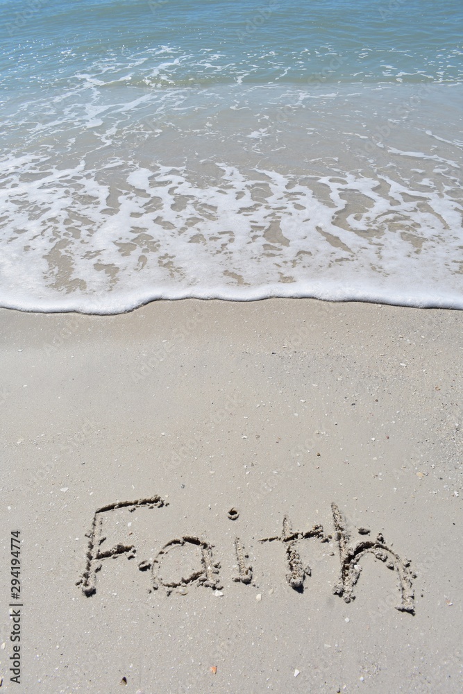 Vertical background of faith written in sand on the beach Vertical background of faith written in sand on the beach