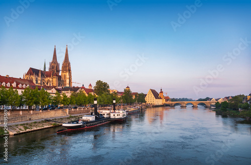 Regensburg cityscape with Danube river embankment St. Peters Cathedral and Stone Bridge Bavaria Germany
