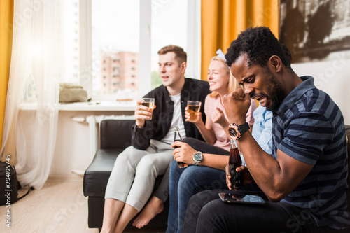 Group of friends watching television at home together