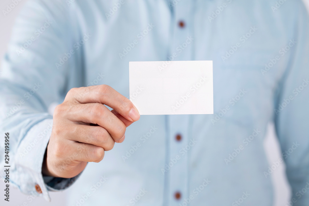 Businessman showing a blank business card on white background Businessman showing a blank business card on white background