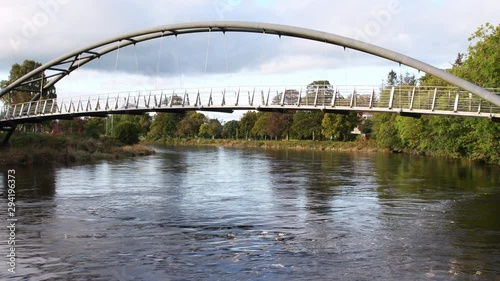 4K video of River Nith and Kirkpatrick Macmillan Pedestrian Bridge in Dumfries in Scotland. The River Nith is a river in south-west Scotland. Water flowing full hd video.