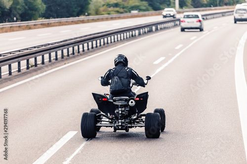 All-terrain vehicle quadbike riding on a highway