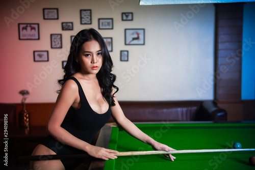 Portrait of asian sexy woman wear black one piece at snooker club,Beautiful Thailand people pose for take a picture