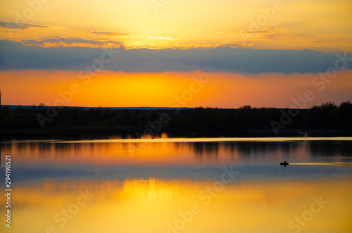 Fototapeta Naklejka Na Ścianę i Meble -  orange sunset on a blue lake