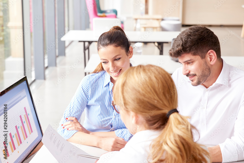 Investment advisor businesswoman and her clients analyze financial statement Investment advisor businesswoman and her clients analyze financial statement