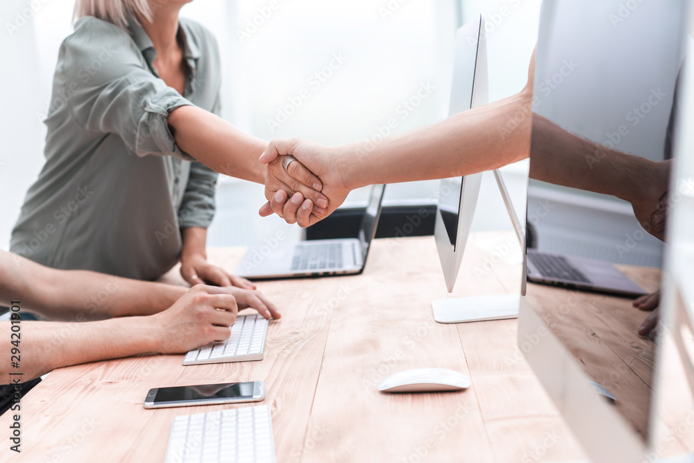 close up. Manager welcomes the client with a handshake close up. Manager welcomes the client with a handshake