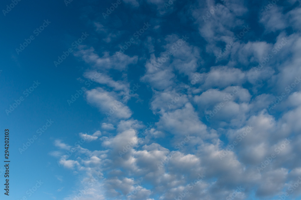 Blue sky with clouds as background, copy space, texture