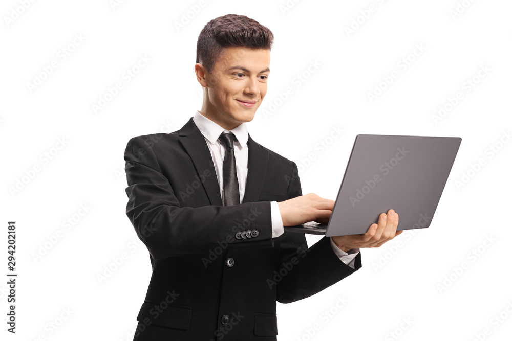 Happy young man in a black suit using a laptop computer