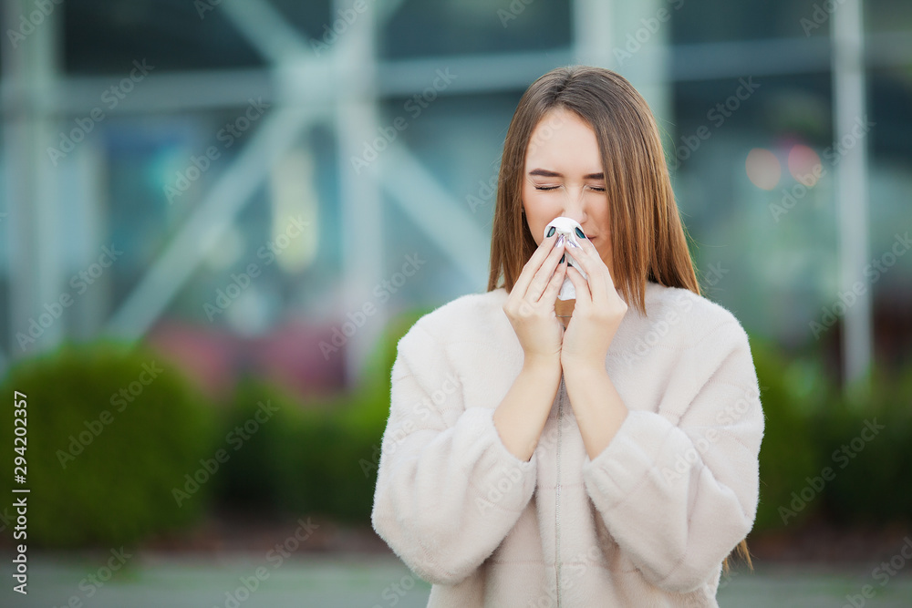 Cold and flu. Upset woman with flu and tissues on outdoor Cold and flu. Upset woman with flu and tissues on outdoor