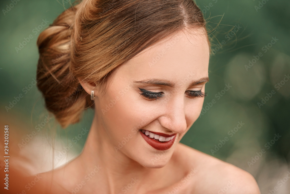 Fototapeta premium portrait of a happy bride on the background of spring foliage