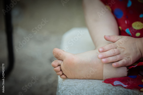 Child, girl has a plaster on a hurt foot. First aid kids.