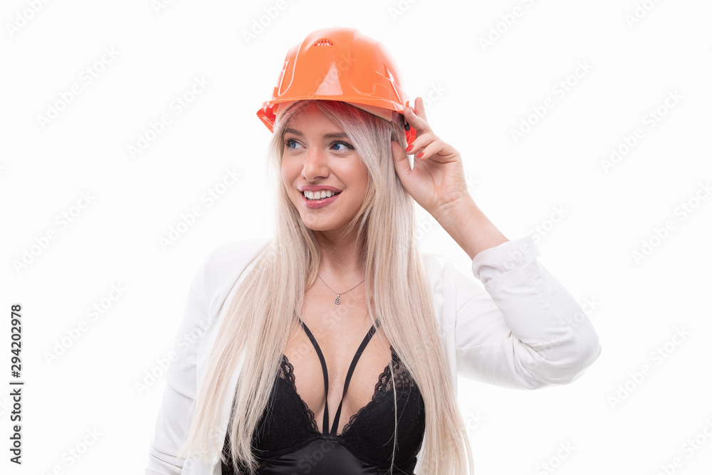 Sexy blonde posing in orange construction helmet Sexy blonde posing in orange construction helmet