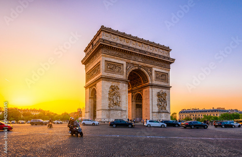 Paris Arc de Triomphe (Triumphal Arch) in Chaps Elysees at sunset, Paris, France. photo