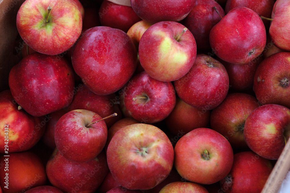 Bunch of organic fresh apples on a market. Apples of medium size. It can be used as a background. Healthy eating concept Bunch of organic fresh apples on a market. Apples of medium size. It can be used as a background. Healthy eating concept