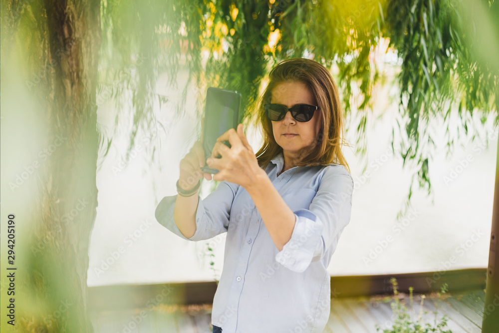 Fototapeta premium Woman making selfie outdoors