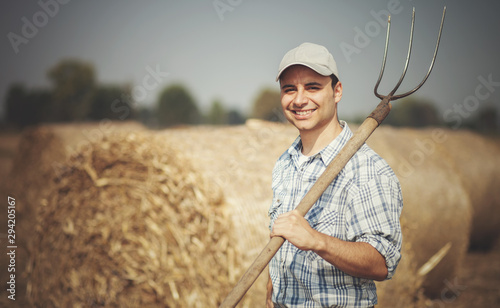 Tablou canvas Farmer holding a pitchfork