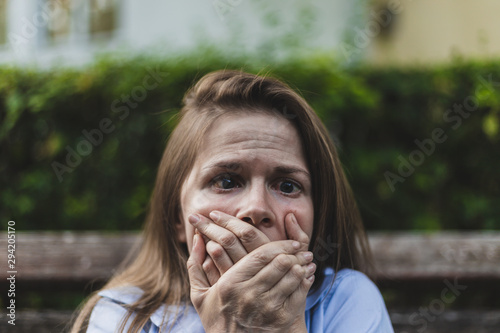 Scared woman covering her mouth