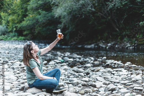 Fototapeta Naklejka Na Ścianę i Meble -  Woman holding a glass of beer