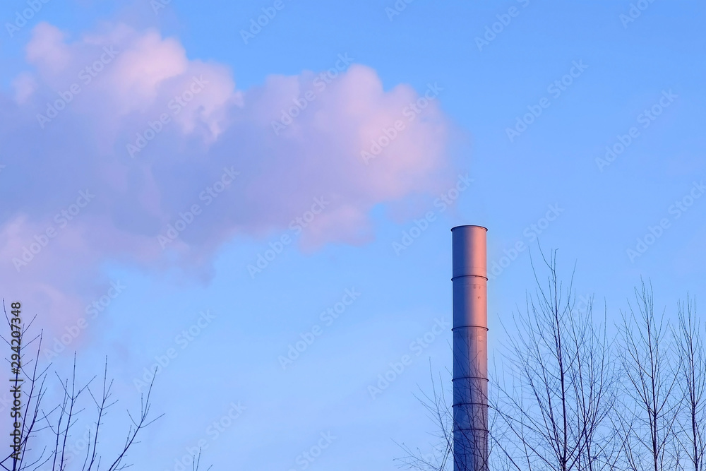 White smoke from the pipes of plant on the outskirts of industrial district
