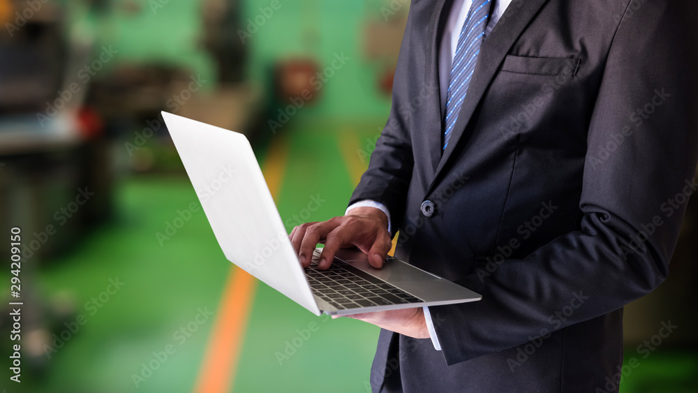 businessman work on laptop in factory businessman work on laptop in factory
