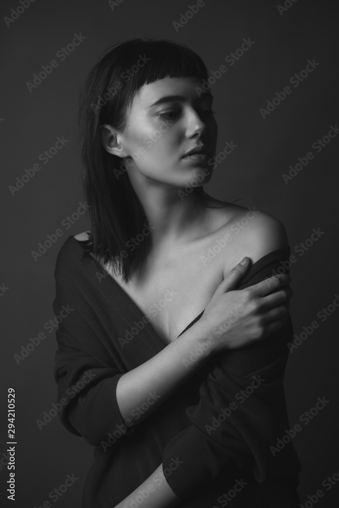 Portrait of beautiful young woman with bare shoulders. Black and white