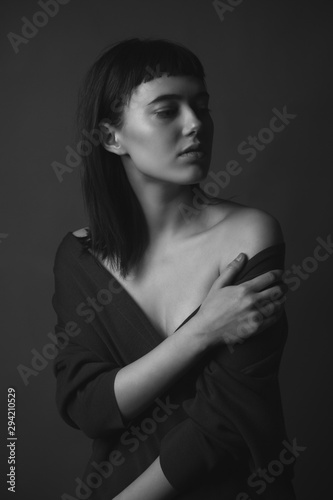Portrait of beautiful young woman with bare shoulders. Black and white