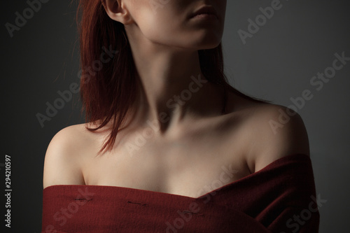 Neck and shoulders of young woman. Studio