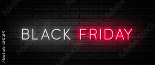 Black Friday sale. Black Friday neon sign on brick wall background. Glowing white and red neon text for advertising and promotion. Banner and background, brochure and flyer design concept photo