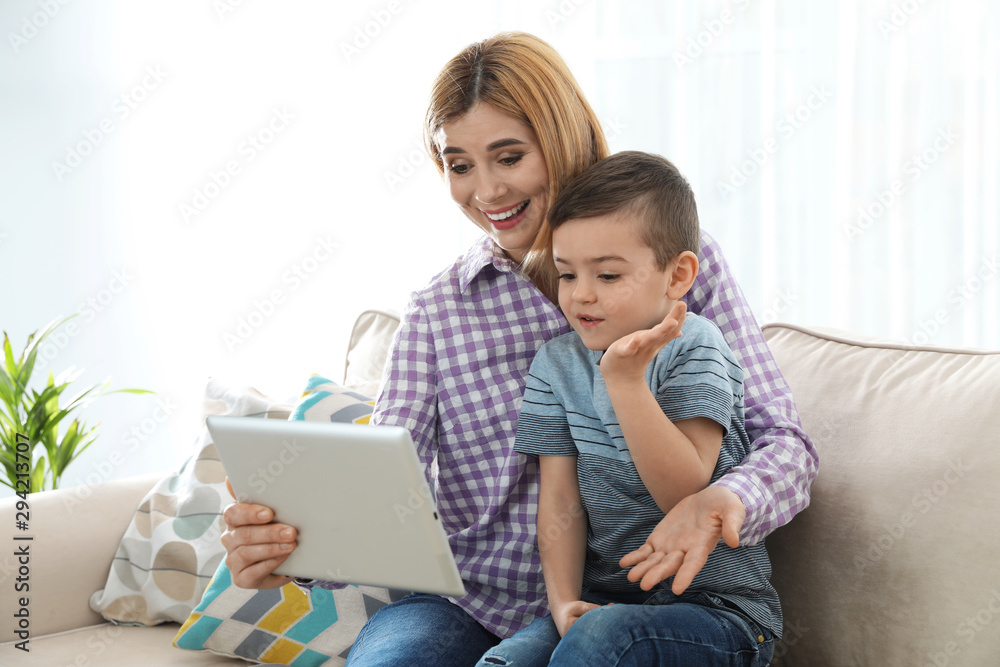 Mother and her son using video chat on tablet at home Mother and her son using video chat on tablet at home