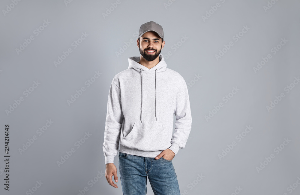 Portrait of young man in sweater on grey background. Mock up for design Portrait of young man in sweater on grey background. Mock up for design
