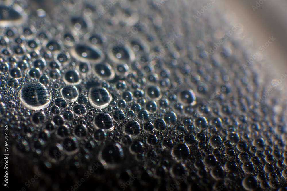 drops of water on metal surface of cola cane