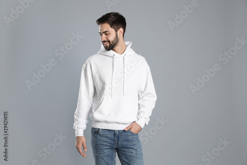 Portrait of young man in sweater on grey background. Mock up for design