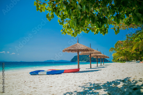Fototapeta Naklejka Na Ścianę i Meble -  Umbrella wooden and kayak on tropical beach.