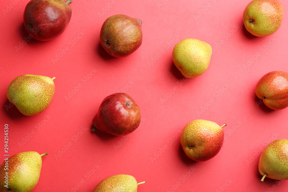 Ripe juicy pears on red background, flat lay Ripe juicy pears on red background, flat lay