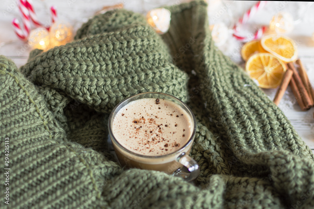 Hot cup of cappuccino or hot milk chocolate with dried orange fruit and cinnamon. Hot cup of cappuccino or hot milk chocolate with dried orange fruit and cinnamon.